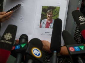 Robert Dziekanski's mother, Zofia Cisowski, shows a photo of her late son in the Braidwood Commission report, while speaking to reporters outside B.C. Supreme Court after former Mountie Benjamin "Monty" Robinson was sentenced for lying to an inquiry in the death, in Vancouver, B.C., on Friday July 24, 2015. The former Mountie who was the senior officer in charge the night Robert Dziekanski was jolted with a Taser and died has been given a two-year jail term for lying to an inquiry into the death. THE CANADIAN PRESS/Darryl Dyck