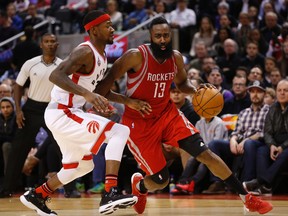 Rockets' James Harden (right) goes inside on Raptors' Terrence Ross (left) and gets the foul during fourth quarter NBA action in Toronto on Sunday, March 6, 2016. (Jack Boland/Toronto Sun)