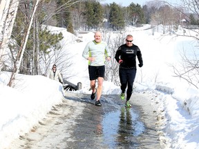 Joggers make their way along the boardwalk in Bell Park in Sudbury, Ont. on Monday March 7, 2016. The forecast for Tuesday calls for a high of 6 degrees C and showers. Gino Donato/Sudbury Star/Postmedia Network