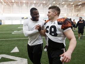 Alex Ogbongbemiga, left, and DJ Lalama shake hands Monday at Edmonton’s Commonwealth Fieldhouse after being selected to attend the national combine in Toronto. (Ian Kucerak)