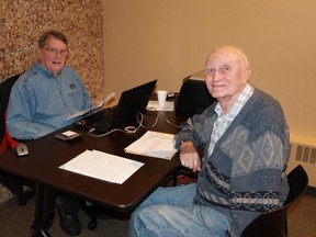 Volunteer Gord Wilson (left) helps out a client with his taxes at the Community Volunteer Income Tax Program, being held at Sarnia Public Library until Apr. 13.
CARL HNATYSHYN/SARNIA THIS WEEK