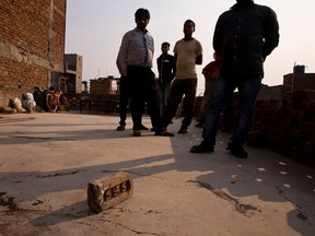 Relatives stand on the terrace of a house where a 15-year-old girl was set on fire after being raped at Tigri village, near Noida, a suburb of New Delhi, India, on March 8, 2016. The girl is fighting for her life in a New Delhi hospital. (AP Photo/Saurabh Das)