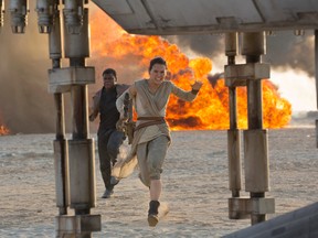 This photo provided by Disney/Lucasfilm shows Daisy Ridley, right, as Rey, and John Boyega as Finn, in a scene from the film, "Star Wars: The Force Awakens," directed by J.J. Abrams. After missing out on a best picture nomination, "Star Wars: The Force Awakens" will get to compete for best picture at the Critics Choice Awards with "Mad Max: Fury Road," which has a leading 13 nominations. The awards will be presented on Sunday, Jan. 17, 2016, in Los Angeles.  (David James/Disney/Lucasfilm)