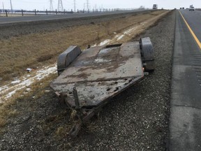 No one was injured, but a police cruiser had some moderate damage after an officer purposely collided with a runaway trailer on Hwy. 401. (Postmedia Network)