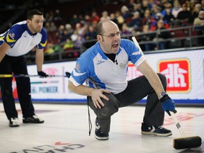 Team Quebec skip Jean-Michel Menard shouts instructions to teammates as Team British Columbia lead Rick Sawatsky looks on at the Brier curling championships in Ottawa on March 8, 2016. (REUTERS/Chris Wattie)