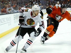 Chicago Blackhawks' Marcus Kruger, left, controls the puck ahead of Anaheim Ducks defenceman Sami Vatanen during first-period action in Anaheim, Calif., on Nov. 27, 2015. (AP Photo/Christine Cotter)