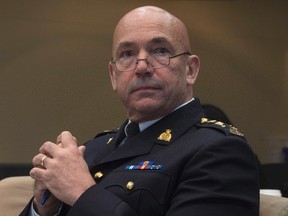RCMP Commissioner Bob Paulson waits to appear before the Commons public safety and national security committee in Ottawa, Tuesday, February 23, 2016. THE CANADIAN PRESS/Adrian Wyld