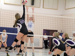 Beaver Brae Broncos left-side hitter Maddie Gan tries to hit the ball past Kingston Blues middle Emily Bruce during action at Beaver Brae Secondary School at the OFSAA senior girls AA volleyball championship in Kenora on Monday. (Sheri Lamb/Postmedia Network)
