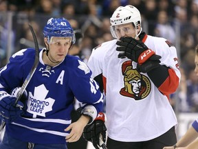 Ottawa Senators defenceman Dion Phaneuf talks with Toronto Maple Leafs centre Leo Komarov during a game at Air Canada Centre in Toronto on March 5, 2016. (Tom Szczerbowski/USA TODAY Sports)