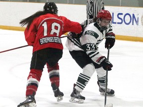 Mother Teresa?s Natalie Warecki slips past Embrun defender Jessica Fournier during the second period of an OFSAA A/AA girls hockey game on Tuesday in Stratford. The Spartans won 6-4 to improve to 1-1.  (Cory Smith/Stratford Beacon Herald)