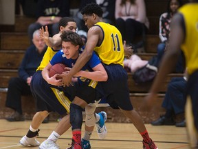 Oakwood’s Nathaniel Nelson (left) and Kadre Gray put a half-court trap on St. Anne’s Blake Ondricko during Round 2 of the AAA OFSAA championships in Windsor on Tuesday. (Dax Melmer/Postmedia Network)