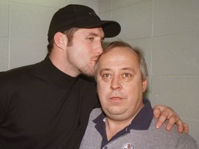 GETTING ALL MUSHY: Freshly traded Oilers heavyweight Bryan Marchment kisses long time Oilers assistant equipment  manager Lyle  Kulchisky in this 1997 photo, which was taken after Marchment was traded to Tampa Bay. (File)