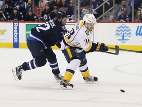 Mar 8, 2016; Winnipeg, Manitoba, CAN; Winnipeg Jets forward Scott Kosmachuk (72) ties up Nashville Predators right wing Viktor Arvidsson (38) during the first period at the MTS Centre. Mandatory Credit: Bruce Fedyck-USA TODAY Sports