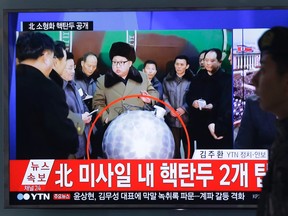 A South Korean army soldier walks by a TV screen showing North Korean leader Kim Jong Un with superimposed letters that read: "North Korea's nuclear warhead" during a news program at Seoul Railway Station in Seoul, South Korea, Wednesday, March 9, 2016. The official North Korean news agency says the communist country's leader Kim met his nuclear scientists for a briefing and declared he was greatly pleased that warheads had been miniaturized for use on ballistic missiles. (AP Photo/Ahn Young-joon)