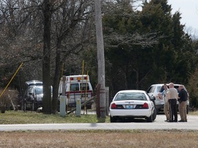 Police gather near the house where a man was found murdered on March 8, 2016, near New Florence, Mo., just south of Interstate 70 near the intersection of Hwy. 19. Dozens of officers searched farmland in central Missouri on Tuesday for a man suspected of killing a man at a nearby house just hours after fatally shooting several people at his neighbour's home about 170 miles away in Kansas. (Cristina Fletes/St. Louis Post-Dispatch via AP)