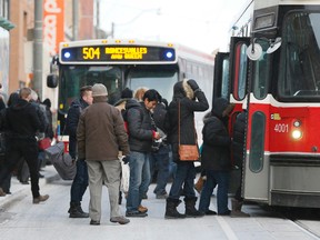 Passengers board a TTC streetcar. (Stan Behal/Toronto Sun files)