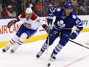 The Leafs' T.J. Brennan moves the puck away from Michael McCarron of the Montreal Canadiens during a preseason game at the ACC on Sept. 26, 2015. (Dave Abel/Toronto Sun)