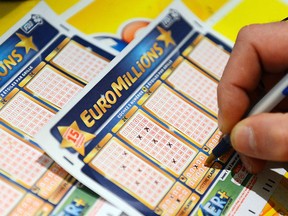 A picture taken on Nov. 5, 2012 shows a man filling an Euro Millions lottery ticket, in Tours, central France.   (AFP PHOTO/ALAIN JOCARD)