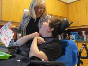 Sue Bendall helps Jeremy Vautour with a shaving cream and paint project during a weekly Hands on Art class Wednesday March 9, 2016 at Standing Oaks, a residence for medically fragile adults in Sarnia, Ont. (Paul Morden, The Observer)