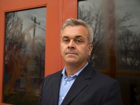 Doug Manners, the business administrator of St. Michael's Parish on Cheapside Street, stands in front of some of the religious symbols painted on their church overnight.Mike Hensen/The London Free Press/Postmedia Network