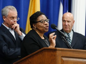 Valerie Wilson, center, school business administrator for the Newark Public Schools system, speaks at a news conference addressing recent finding of lead levels in Newark schools, Wednesday, March 9, 2016, in Newark, N.J.  (AP Photo/Julio Cortez)