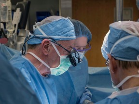 In this Wednesday, Feb. 24, 2016, photo provided by Cleveland Clinic Center, a team of Cleveland Clinic transplant surgeons and gynecological surgeons perform the nation's first uterus transplant during a nine-hour surgery in Cleveland. (Cleveland Clinic Center via AP)