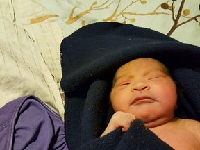 This Tuesday, March 8, 2016 photo provided by Roseanne McCulloh shows a baby girl in Mesa, Ariz. Police were searching Wednesday for the parents of the newborn baby girl who was left in front of the suburban Phoenix home, her umbilical cord still attached. (Roseanne McCulloh via AP)