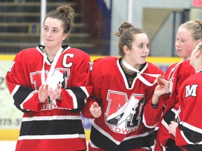 Medway captain Emily John, left, Madison Melo, Madison Fisher and Caitlyn Gerrits celebrate after beating Cobourg 1-0 in the bronze-medal game at the OFSAA AAA girls hockey championship in Stratford on Wednesday. (CORY SMITH, Postmedia Network)
