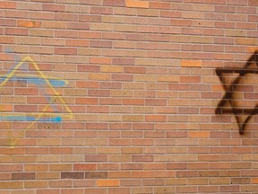 Two Stars of David along with other symbols and tags were found on the windows and walls of of St. Michael's Parish on Cheapside Street in March. (Free Press file photo)