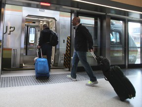 Passengers board the UP Express at Union Station on the first day of lower fares Wednesday March 9, 2016. (Veronica Henri/Toronto Sun)