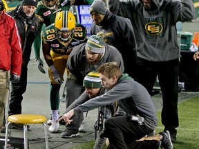 Edmonton Eskimos personnel react as they watch the replay after a fumble and touchdown return was called back at Commonwealth Stadium in Edmonton on Nov. 22,  2015. (Tom Braid/ Sun/Postmedia Network.)