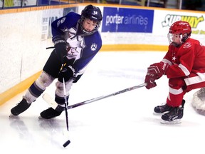 Sudbury Wolves AAA major peewees' Max McCue works his way around a Soo Greyhounds defender during league semifinal action at Carmichael Arena on Wednesday night.