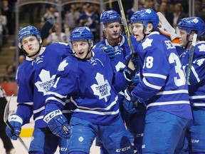 Leafs forward Zach Hyman (second left) is mobbed by teammates after scoring during first period NHL action against the Islanders in Toronto on Wednesday, March 9, 2016. (Stan Behal/Toronto Sun)
