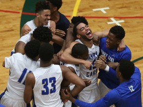 Henry Carr players celebrate as the game ends after defeating Oakwood  to win the OFSAA boys championship at St. Clair College in Windsor on Wednesday. (Jason Kryk/Postmedia Network)