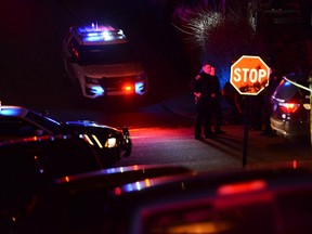 Police investigate the scene after a shooting on Wednesday, March 9, 2016, in Wilkinsburg, Pa. Police say five people have been killed in a shooting in suburban Pittsburgh and at least two gunmen are at large. Allegheny County police say four women and a man were killed late Wednesday during a backyard party in the Borough of Wilkinsburg. At least three others are in stable or critical condition at hospitals. (Michael Henninger/Pittsburgh Post-Gazette via AP)