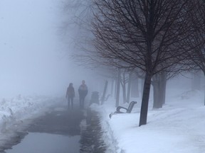 Julie Soulliere and Calvin Waine enjoy the warm temperatures while taking a foggy walk at Bell Park on Wednesday March 9, 2016. Gino Donato/Sudbury Star/Postmedia Network