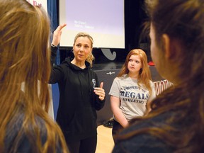 Angella Goran, second left, a former national athlete in rowing, cycling and triathlon and a Fitspirit ambassador, talks to Marymount Academy students Caitlyn Weirmeir, left, Malory Street, and Rebecca Lalone, right, at the high school in Sudbury, Ont. on Wednesday March 9, 2016. John Lappa/Sudbury Star/Postmedia Network