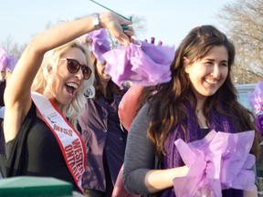 Britt Yolkowskie and Danielle Kennedy took part in the International Women's Day celebration Tuesday, Mar. 8.They were two of over fifty women who met near the Fifth Street Bridge, and then paraded downtown with purple pompoms. Photo taken Mar. 8 in Chatham, ON.