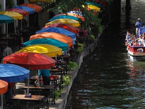 In this July 11, 2011 file photo, tourists take a boat ride along the River Walk in San Antonio. Visitors can enjoy the River Walk day or night, so it’s a good option for business travelers trying to squeeze some  sightseeing into a busy schedule. (AP Photo/Eric Gay, File)