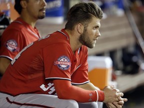Washington Nationals' Bryce Harper watches from the dugout in the eighth inning of a baseball game against the Miami Marlins, Saturday, Sept. 12, 2015, in Miami. The Marlins defeated the Nationals 2-0. (AP Photo/Lynne Sladky)