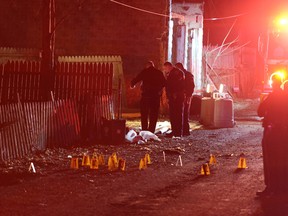 Police investigate the scene after a deadly shooting in Wilkinsburg, Pa., on March 9, 2016. Police say multiple people were killed in the shooting and several were injured in suburban Pittsburgh. (Michael Henninger/Pittsburgh Post-Gazette via AP)