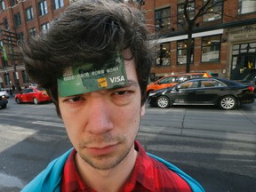Bran Ramsey , 26, was scammed by a Toronto cab driver,  switching his debit card with another, and nearly draining all the funds from his bank account last Friday morning at Spadina and King West in downtown Toronto. (Editor's Note - Debit Numbers Changed to 0000 to Prevent Further Fraud) (photo illustration) Tuesday March 8, 2016. Stan Behal/Toronto Sun/Postmedia Network