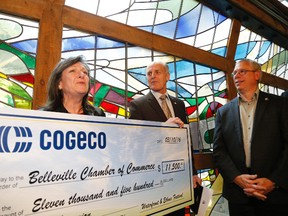 Jason Miller/The Intelligencer
Cogeco Connexion president and CEO Louise St-Pierre hands over a sponsorship cheque for $11,500 to Belleville and District Chamber of Commerce CEO Bill Saunders (centre) for the annual Waterfront and Ethnic Festival as Coun. Jack Miller looks on. There were no details provided on the annual summer festival during a press conference at city hall on Thursday.