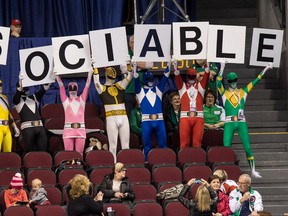 A group of fans from Alberta called Sociable wearing Power Ranger costumes cheer at the 2016 Brier in Ottawa on Thursday March 10, 2016.