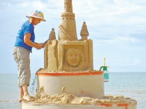 Sandi (Castle) Stirling creates a work of sand art at the Cobourg Sandcastle Festival.