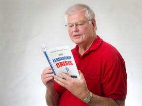 Former London politician and author Gord Hume poses for a photo with a copy of his new book, The Leadership Crisis. (CRAIG GLOVER, The London Free Press)