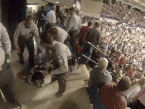 Rakeem Jones lies on the ground while being removed by deputies from a Donald Trump rally in Fayetteville, North Carolina March 9, 2016, in a still image from video provided by Ronnie Rouse March 10, 2016. Jones was assaulted during his eviction from the rally, and a man faces criminal charges in the altercation. REUTERS/Ronnie C/Handout via Reuters