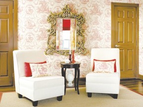 Designers Colin and Justin created this tableau by finishing the doors with a graining kit, adding wallpaper to blank walls, pairing up slipper chairs, adding focus with an ornate mirror and rolling out an area rug that adds texture and focus.