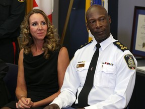 Police Chief Devon Clunis and wife Pearlene listen during a press conference at the Public Safety Building in Winnipeg to announce his retirement from the force on Thu., March 10, 2016.