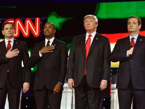 Republican U.S. presidential candidates (left to right) Senator Marco Rubio, Dr. Ben Carson, businessman Donald Trump, and Senator Ted Cruz stand onstage together during the singing of the U.S. national anthem the Republican presidential debate in Las Vegas, Nevada in this December 15, 2015 file photo. (REUTERS/David Becker/Files)